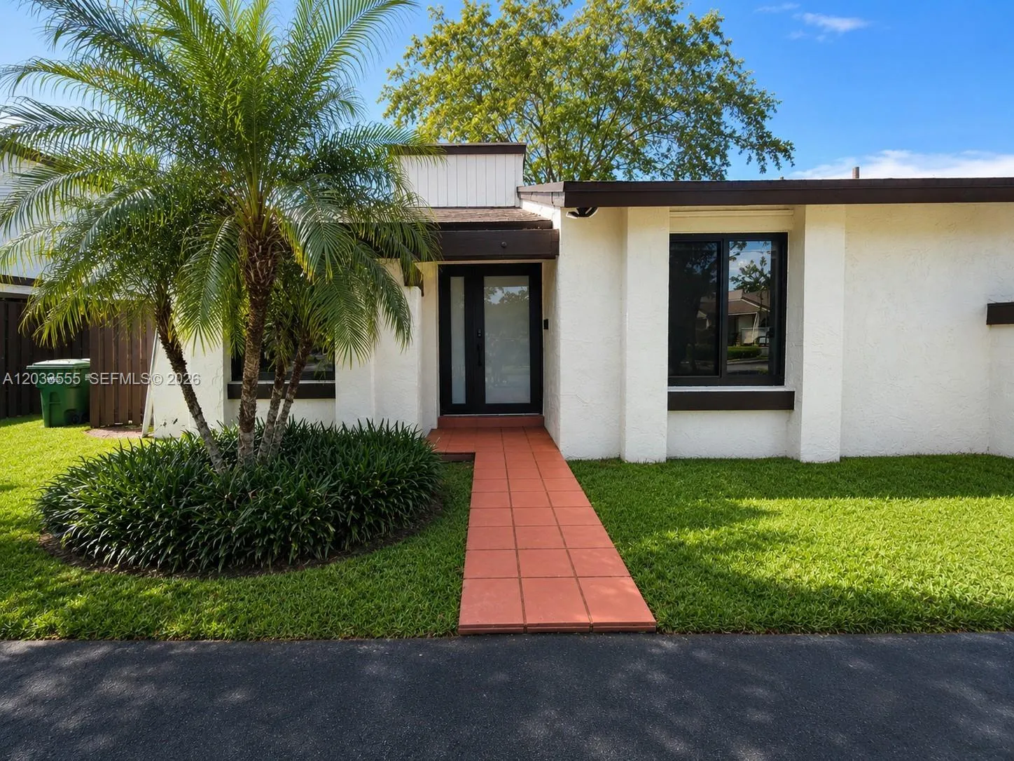 Front exterior of the home featuring the main entryway and designated parking space.