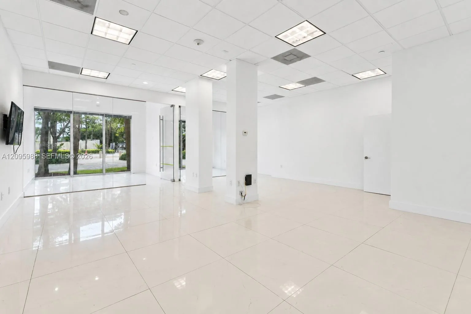 Open suite interior toward storefront glazing
