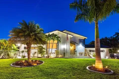 A tropical dream mansion glowing like it's ready for a beach party with the stars!