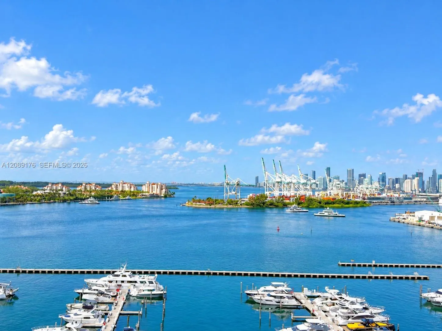 Breathtaking open balcony view of Biscayne Bay, marina, and Miami Beach skyline
