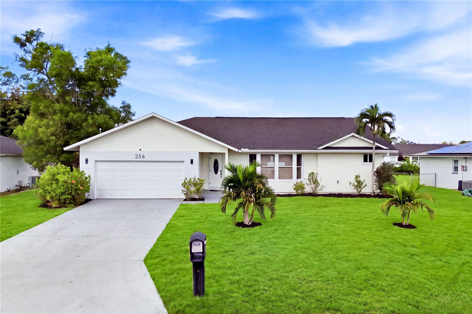 Attractive curb appeal welcomes you w/ tropical palms, expansive lawn & attached 2-CAR GARAGE.