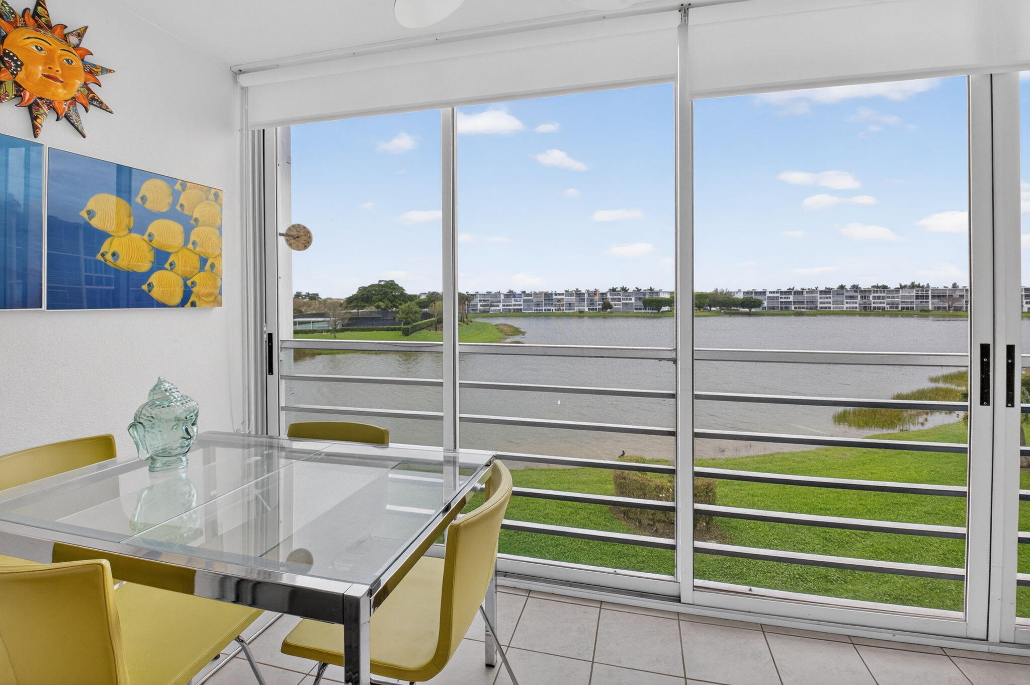 Enclosed balcony has sliding glass doors that opens to screens to enjoy Florida's beautiful weather