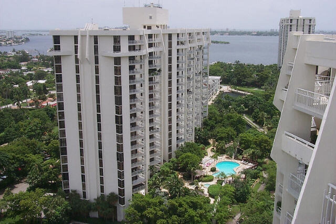Multi-story residential complex featuring white-painted facades and numerous private balconies