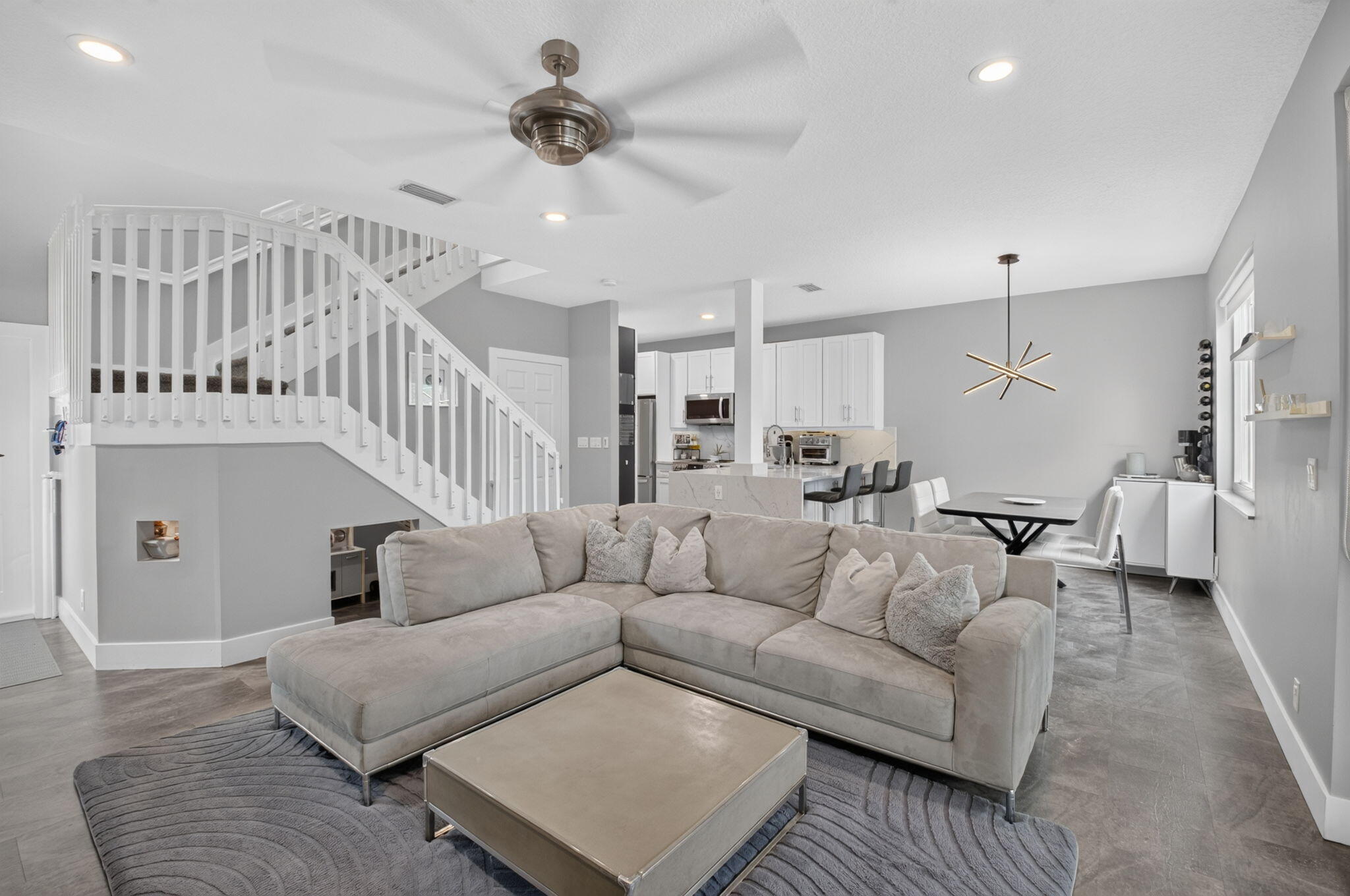 Oversized Great Room with impact windows, recessed lights, half bathroom, garage access, and renovated kitchen.