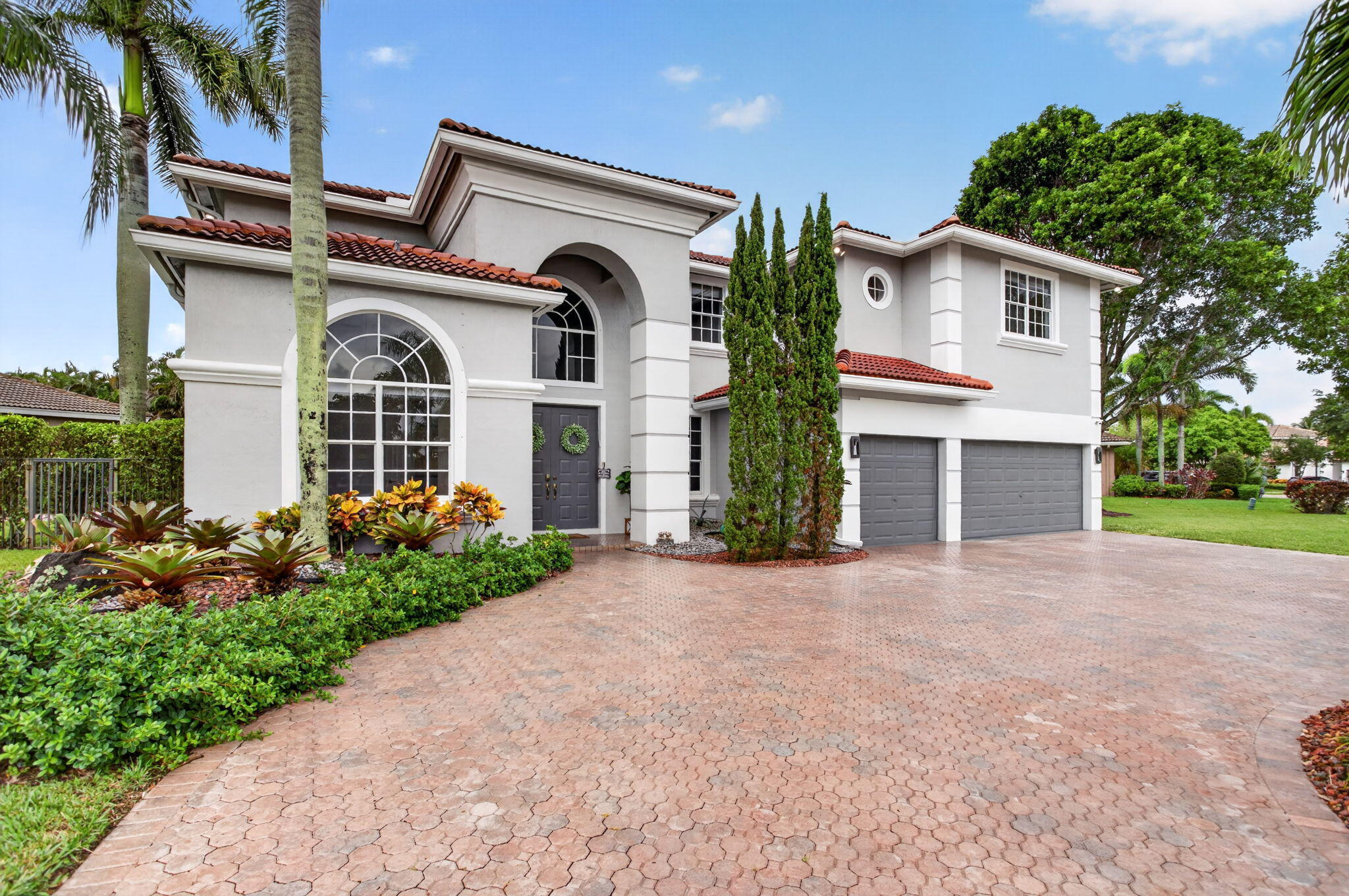 Oversized circular driveway with three car garage