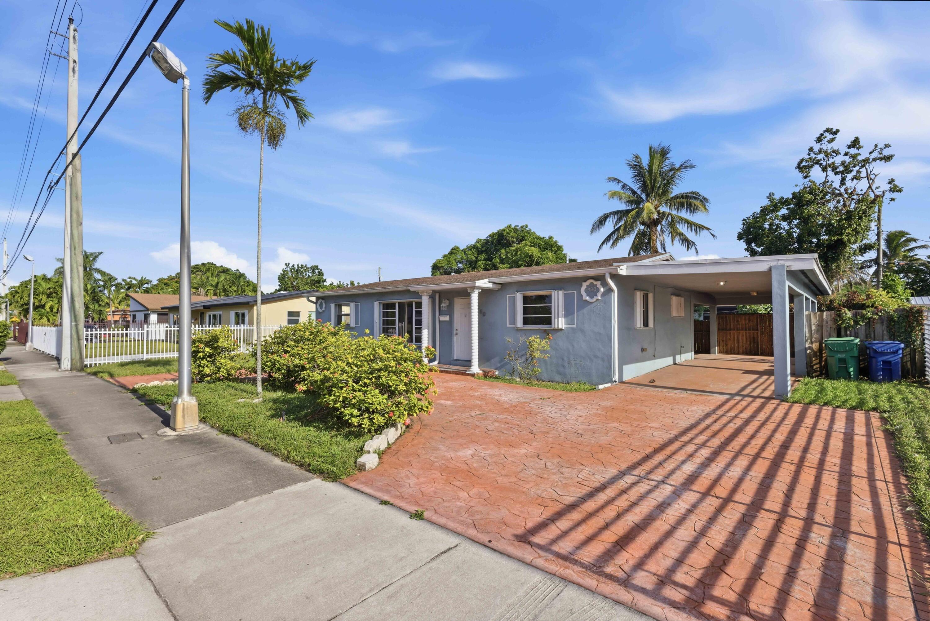 Front of house. Circular Driveway and large carport.