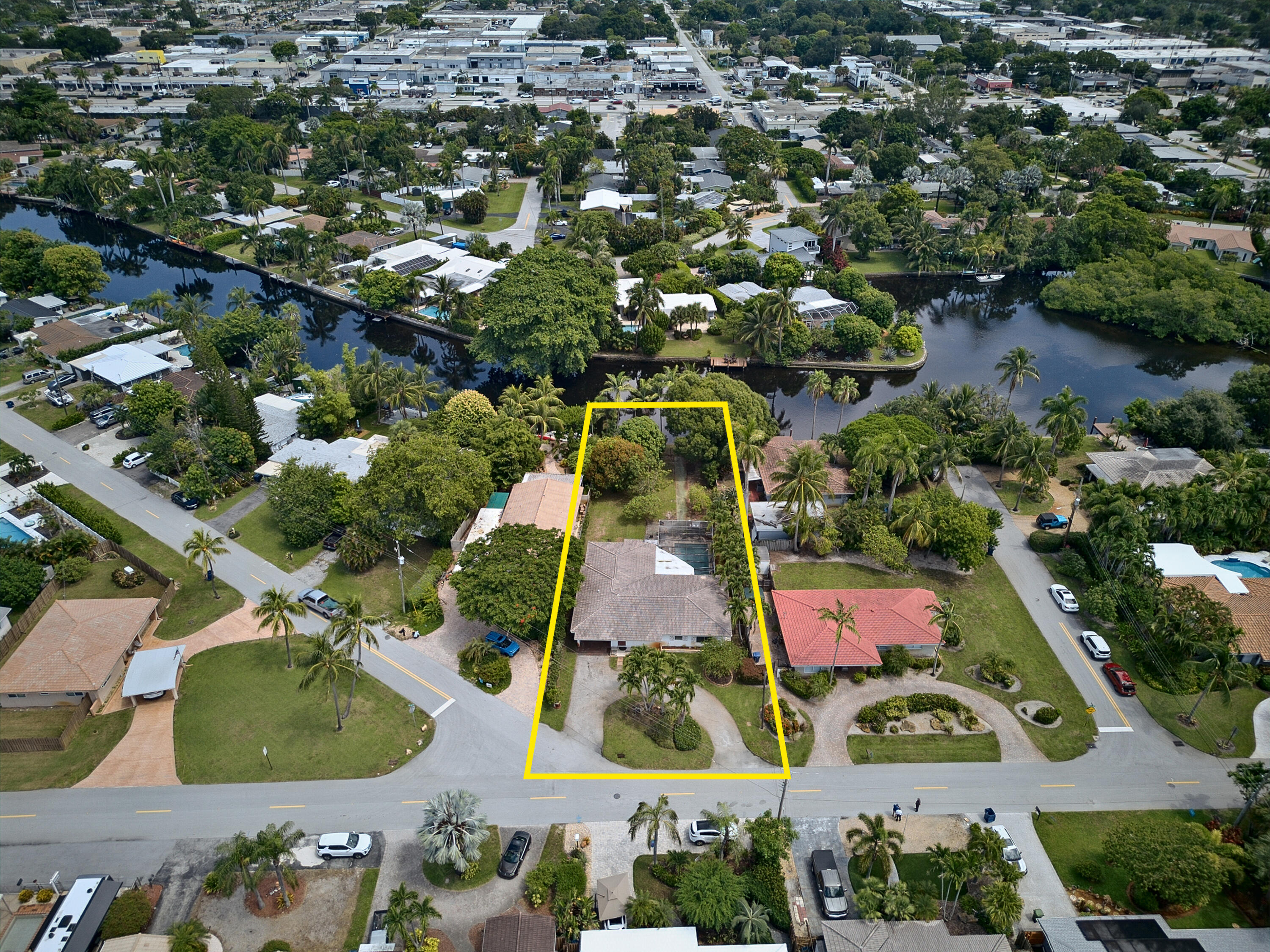 Aerial view highlights the property’s substantial lot, waterfront setting and excellent renovation or redevelopment potential.