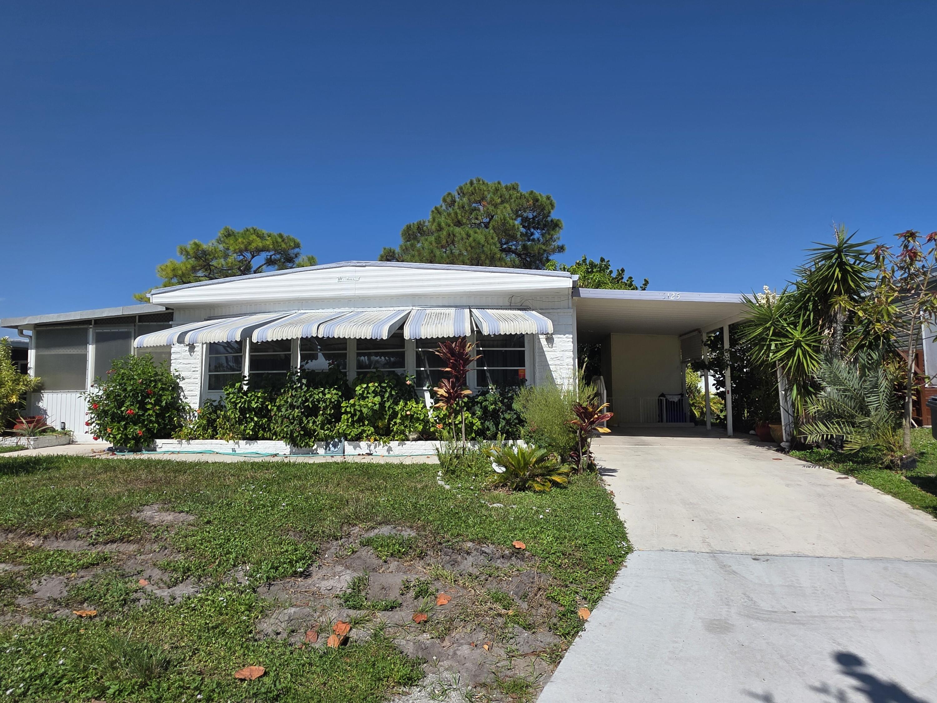 Foto de propiedad en 6125 N Guava Lane, Atlantis, FL 33462 Atlantis con MLS# 