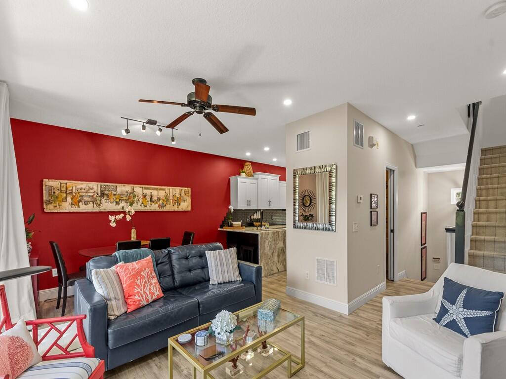 Recessed lighting, wood-finish flooring, ceiling fan, track lighting, and a built-in kitchen counter with cabinetry