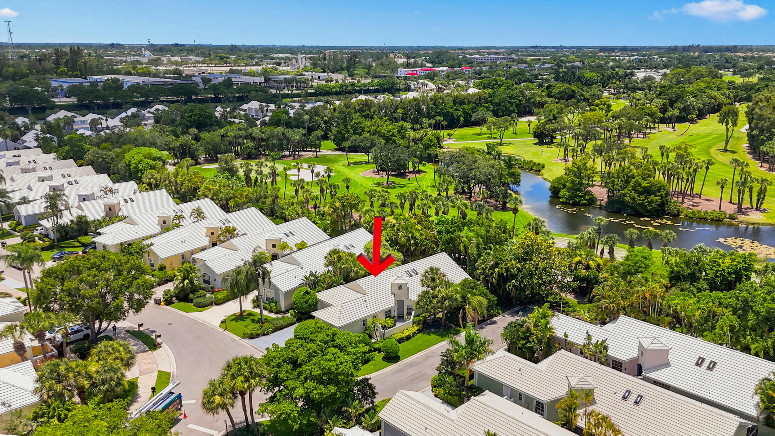 Wide aerial view showcasing the home, surrounding neighborhood, and nearby recreational areas.
