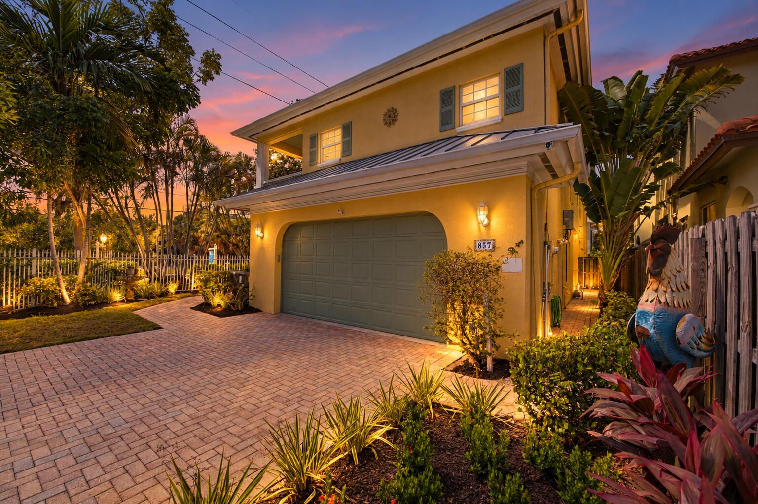 Modern two-story residence featuring a welcoming illuminated facade with warm architectural lighting