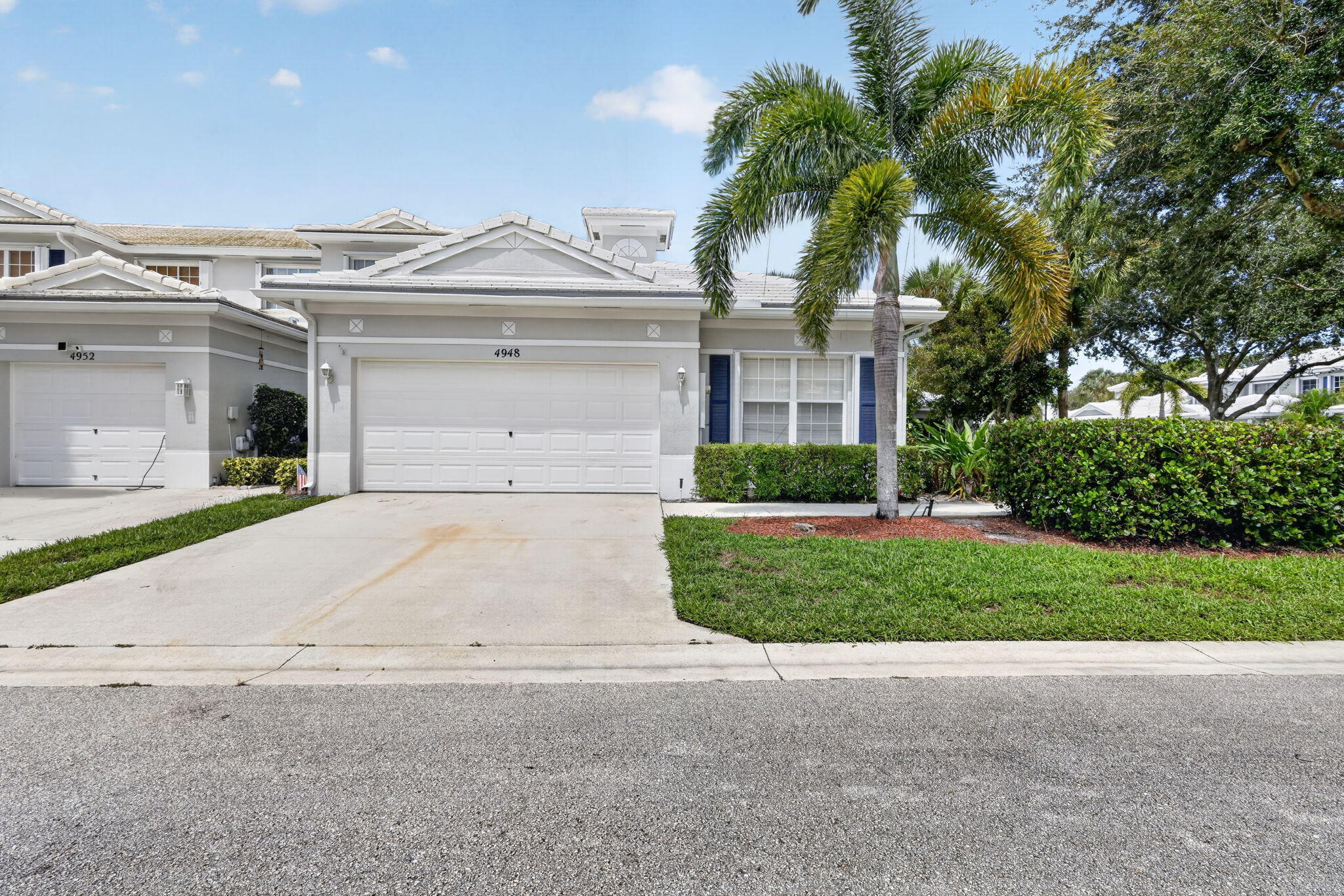 Attached garage with a paved driveway