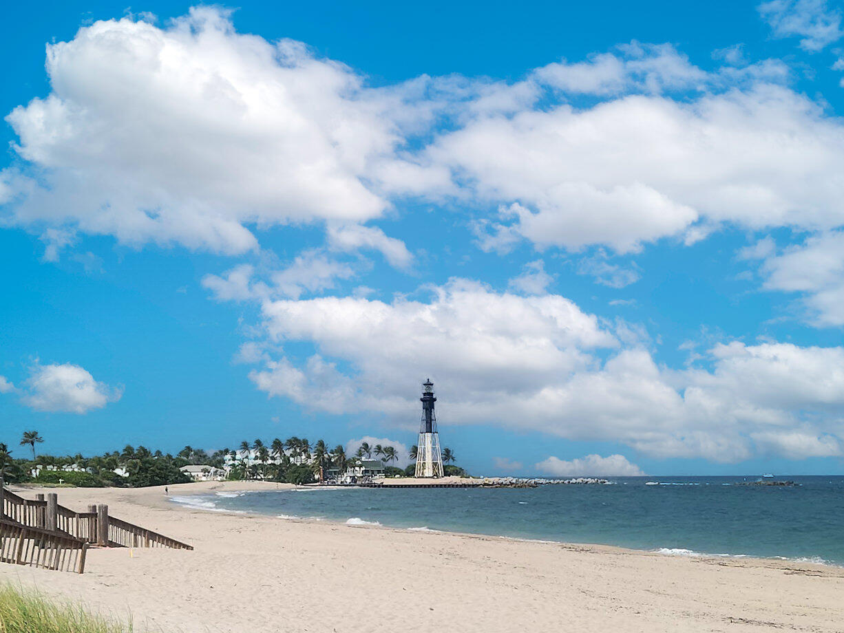 Expansive sandy beach with ocean frontage and beautiful lighthouse view