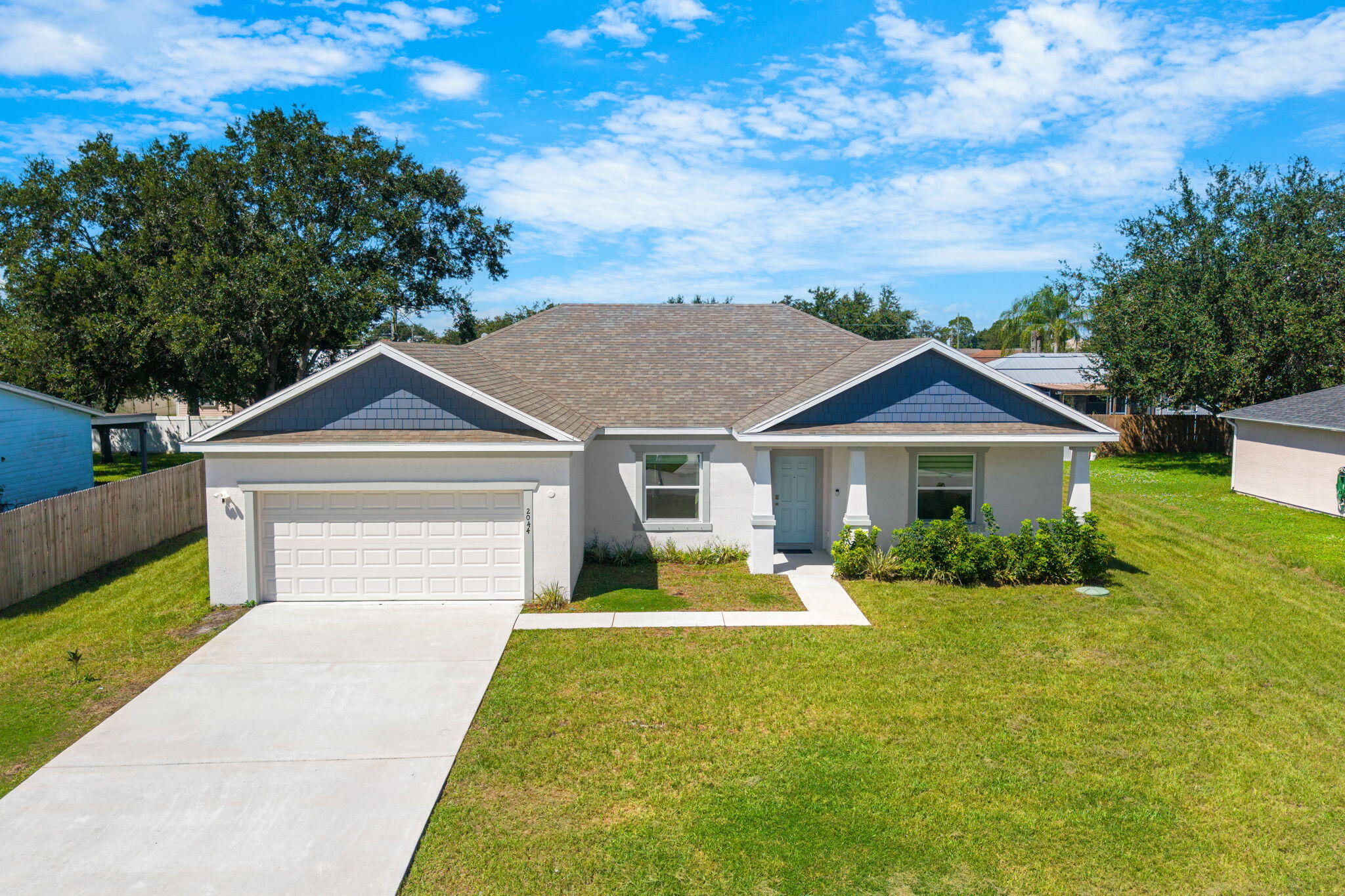 Single-story residence featuring a two-car garage, concrete driveway, and a covered entryway