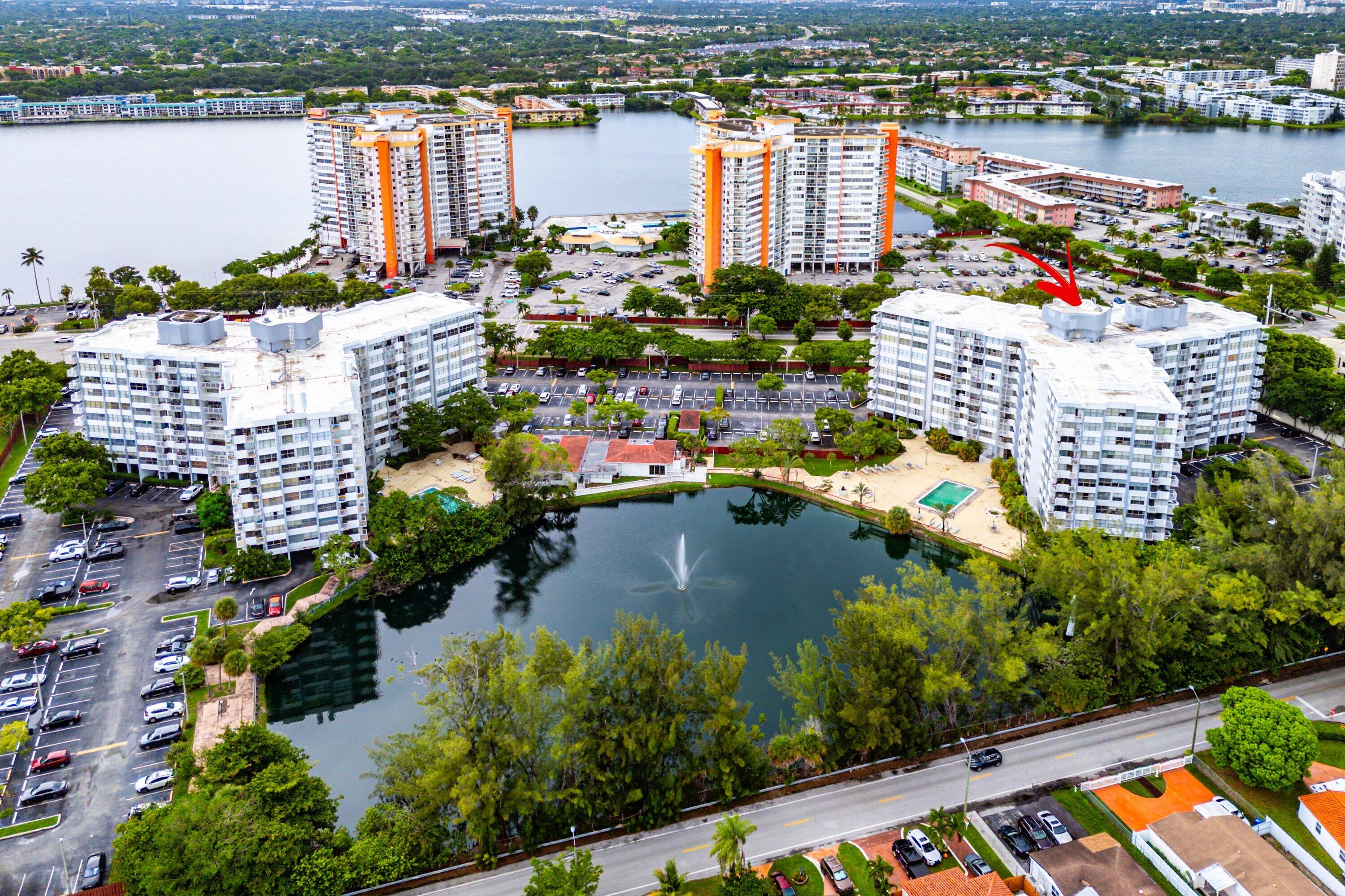 Multi-story residential buildings with water features and surrounding landscaping