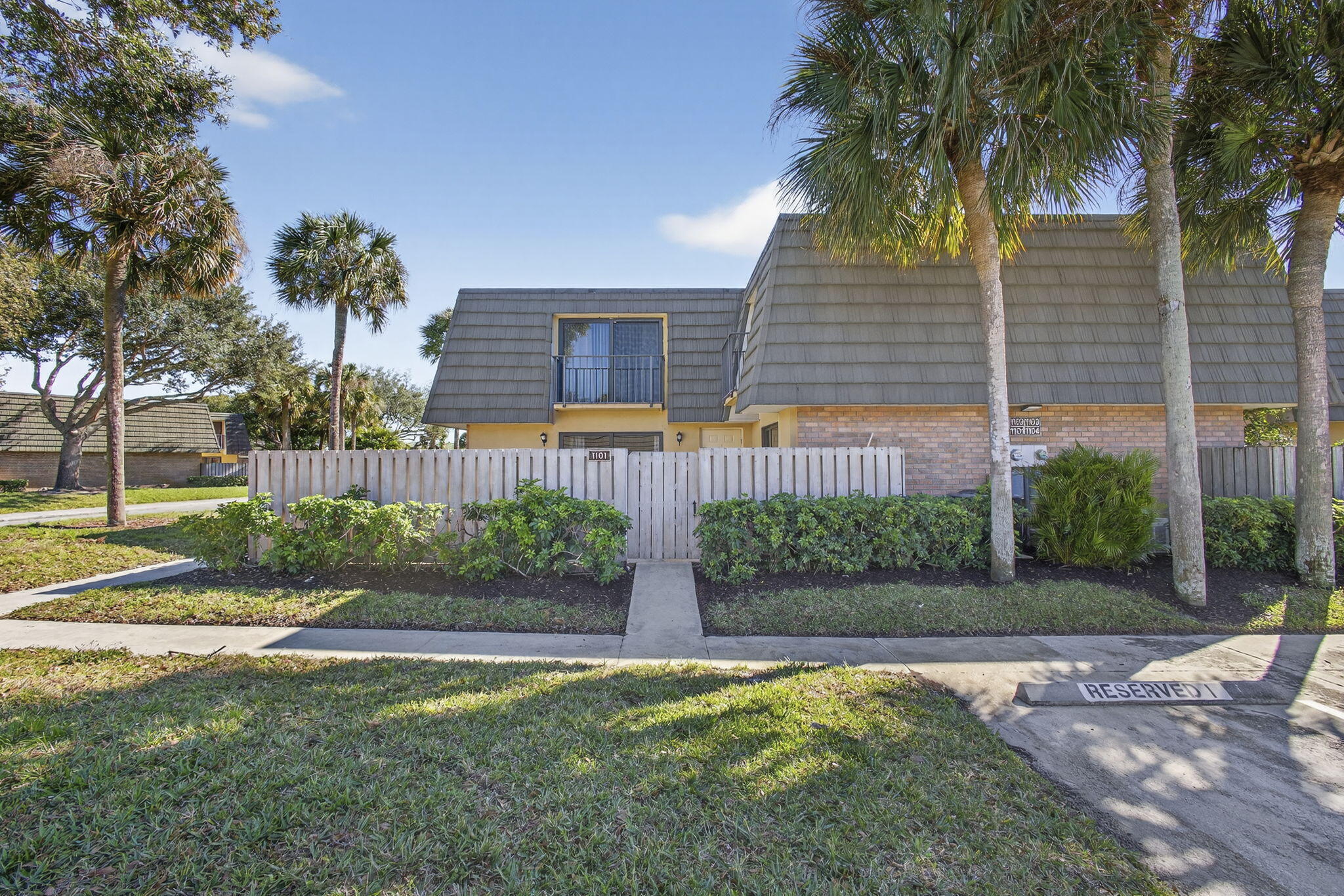 Front exterior leading to private fenced patio area