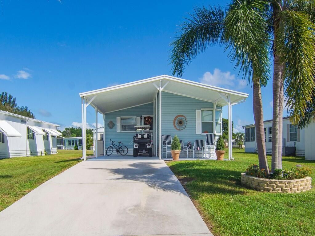 Light blue siding exterior with a covered carport