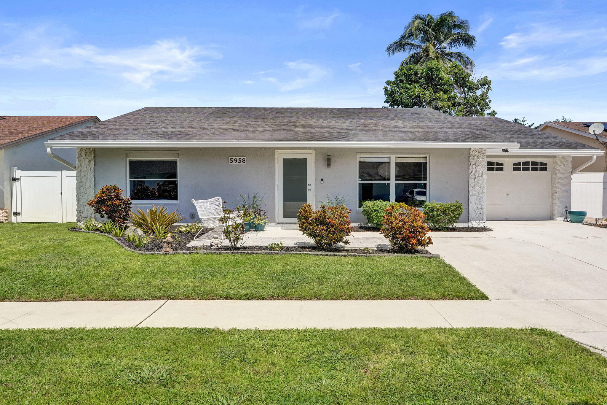 Single-story exterior with stucco finish and a composite shingle roof
