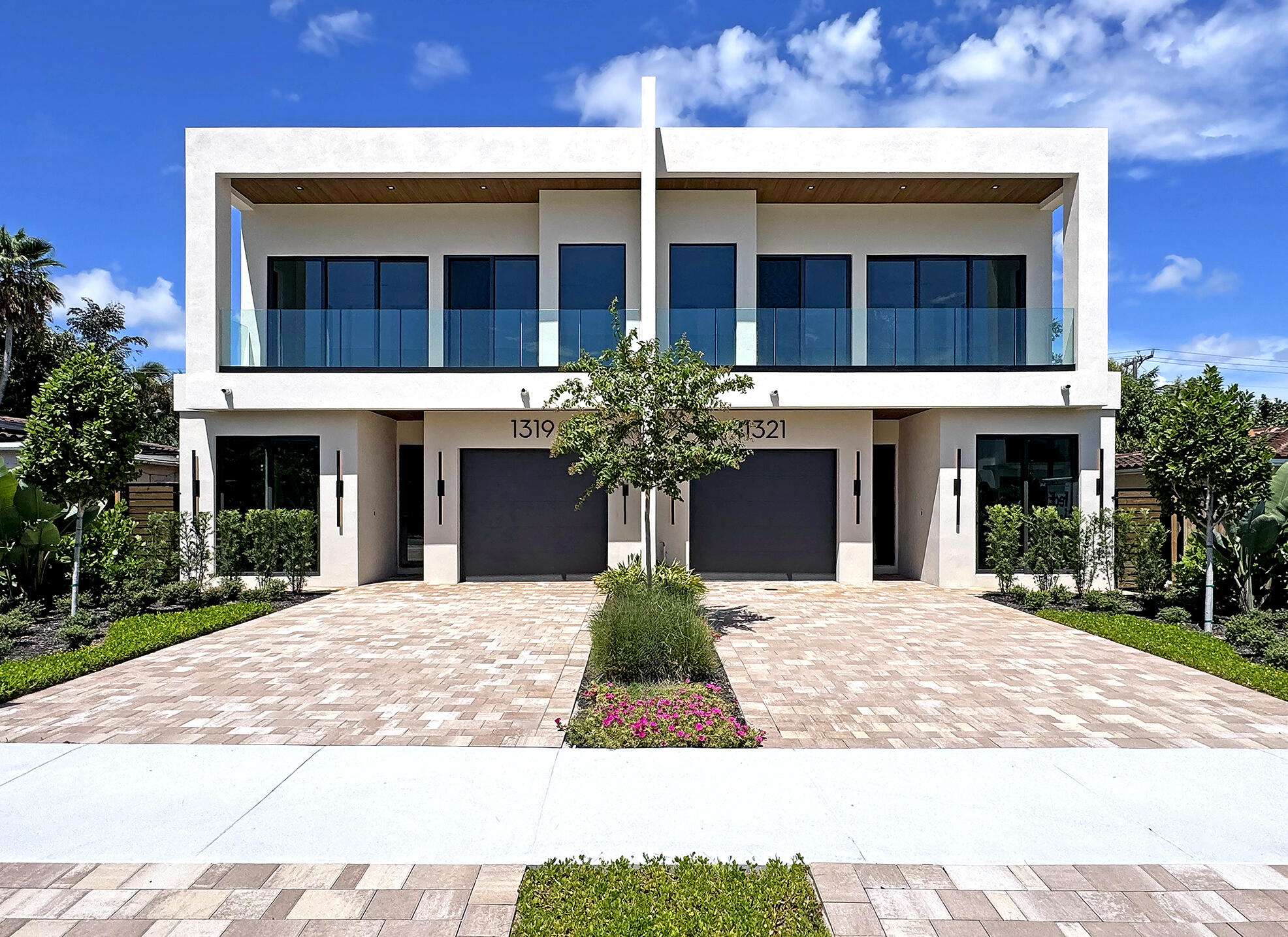Front elevation facing East. Beautifully landscaped. Modern with warm tones and dimension.