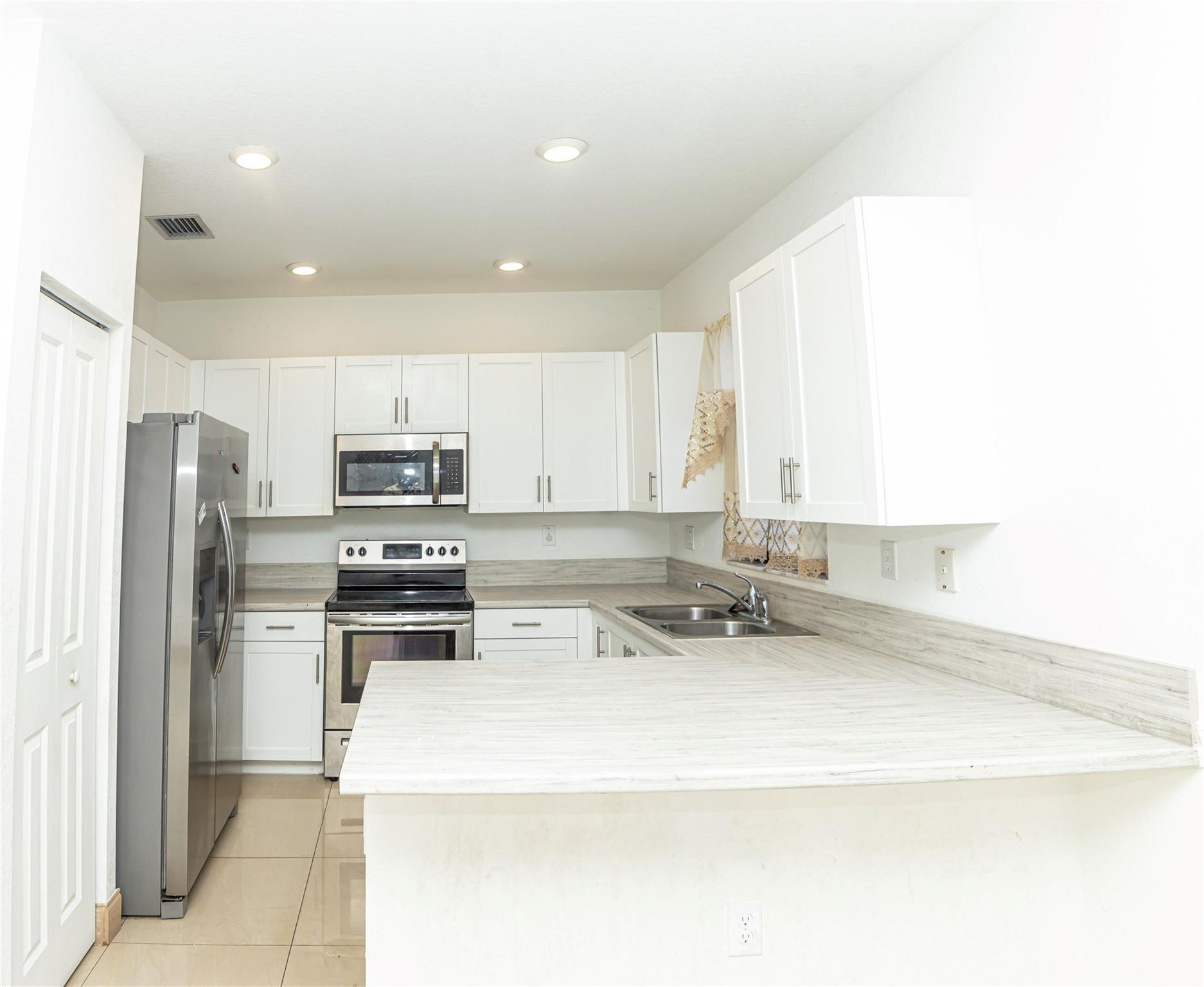 cabinetry, generous counter space, and a layoBright functional kitchen with ample ut perfect for cooking and gathering