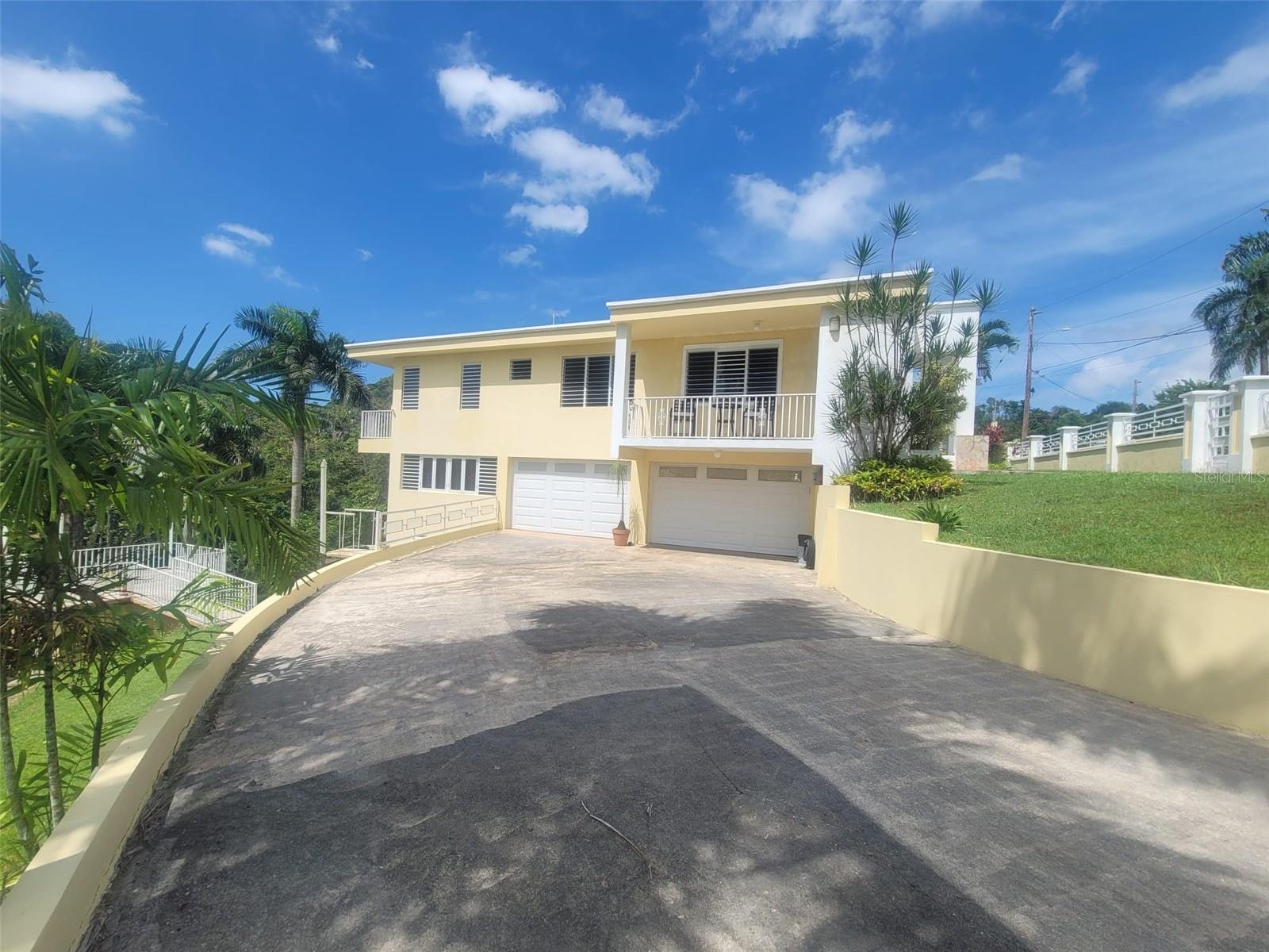 Hacienda del Dorado, Dorado, Puerto Rico property offering 4 bedrooms, 2.5 bathrooms, 2,500 sq. ft. of living space on a 3,947 sq. meter lot. Gated community with 24-hour security and excellent access to main roads in Dorado. Spacious layout with double carport for 4 vehicles and lower-level areas with plumbing and electrical ready for future conversion. Large lot provides privacy and expansion potential in a prime Dorado residential location.