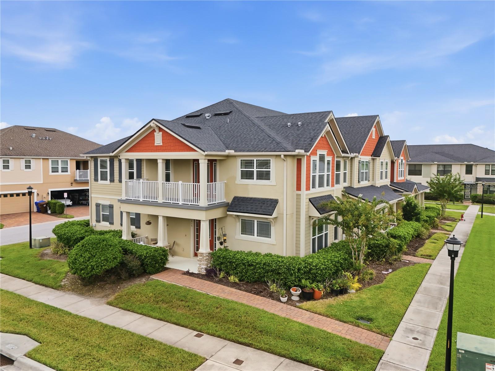 Desirable end-unit townhome offering additional windows, enhanced privacy and extra green space along the side, complemented by a covered front porch, spacious second-floor balcony and charming architectural details.